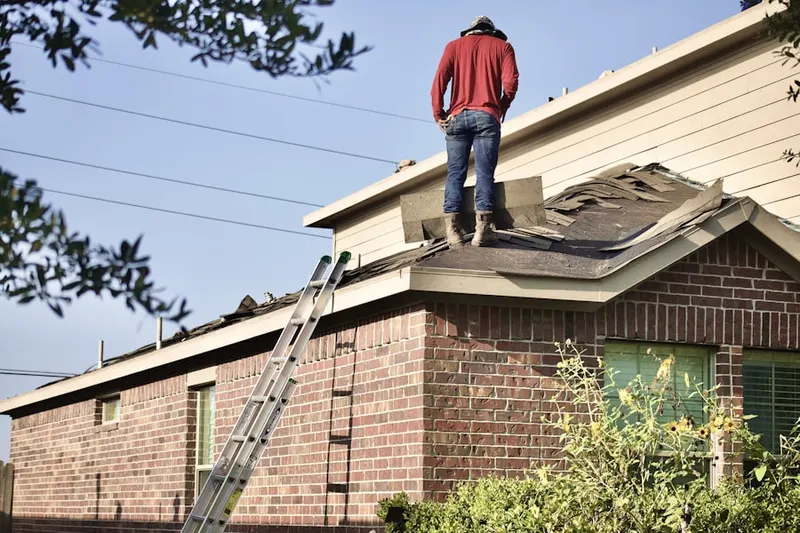 Professional roofer working on a residential roof in Leicester